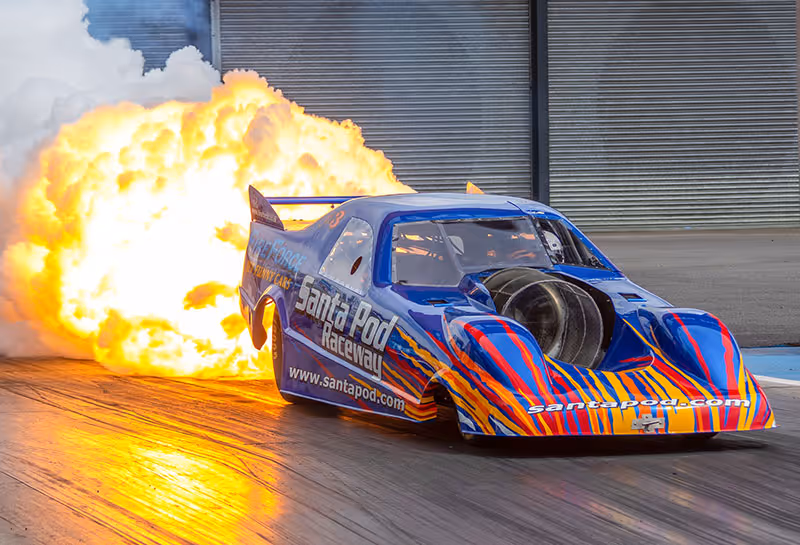 A jet car shooting flames at Santa Pod Raceway
