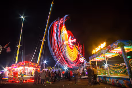 Funfair rides lit up at night