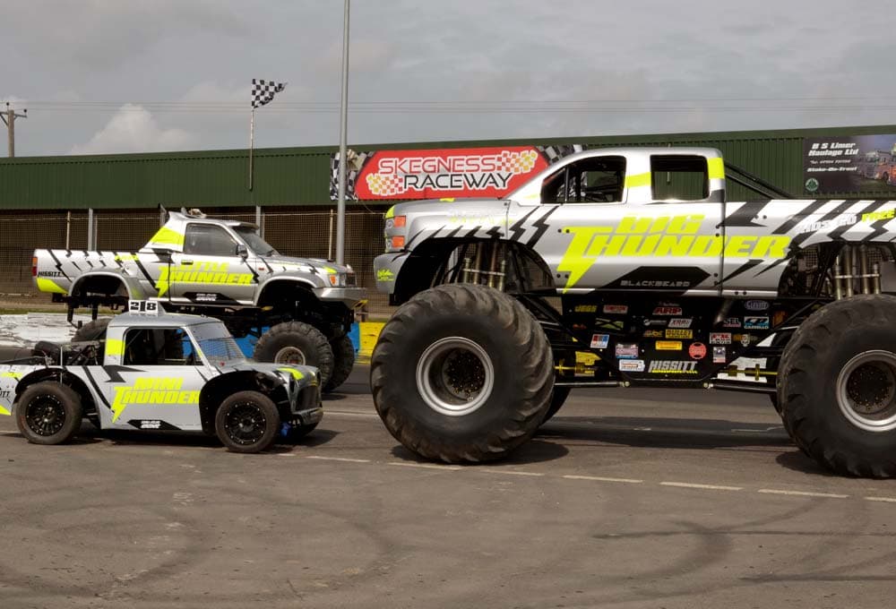 Big Thunder parked beside two smaller trucks in matching colours