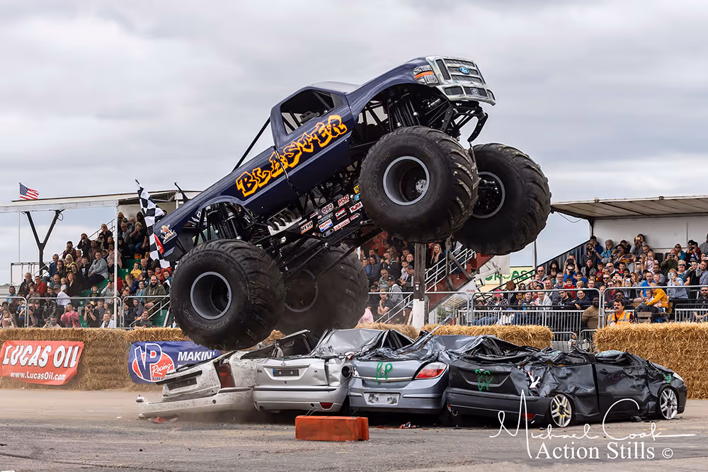 Blaster rearing up as it drives over crushed cars