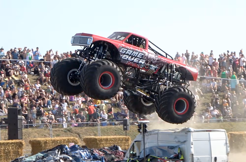 Game Over in mid-air above crushed cars and a van