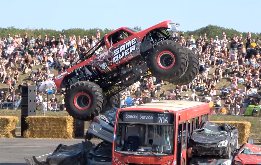 Game Over landing on a red bus and a pile of cars