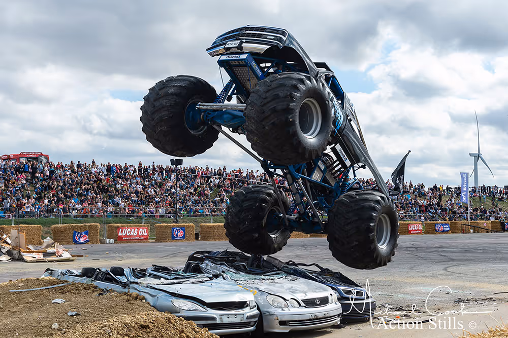 Grim Reaper standing up on its rear wheels on top of crushed cars
