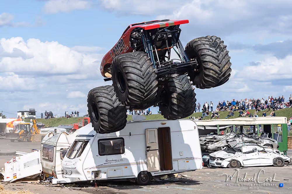 Lambo in mid-air above a caravan and wrecked cars
