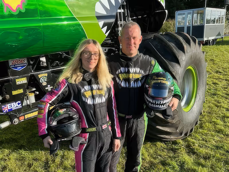 Tony and Georgina Dixon, the Swamp Thing team, standing by the truck's wheel